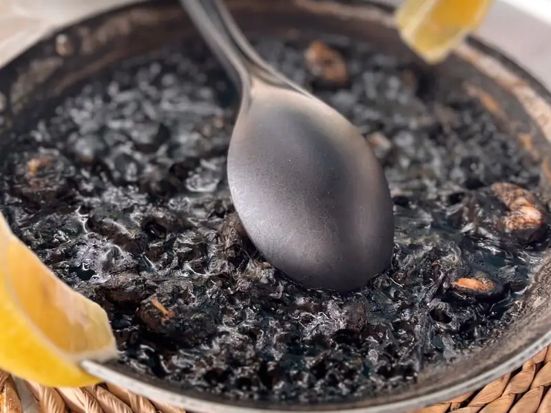 Paella de arroz negro en la paellera